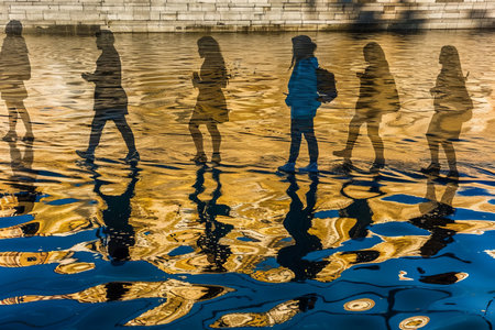 people walking in water reflectionの素材