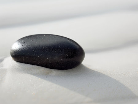 black pebble on sandy beachの素材