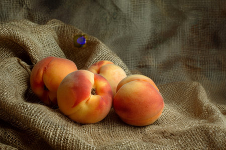 fresh ripe peaches on burlap clothの素材