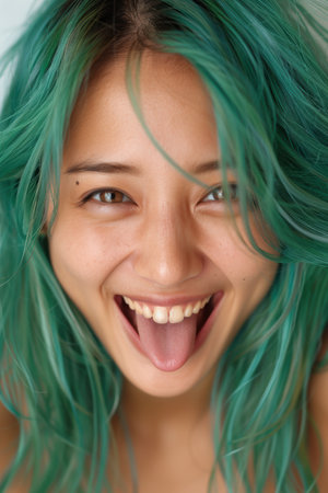 Joyful woman with vibrant green hairの素材