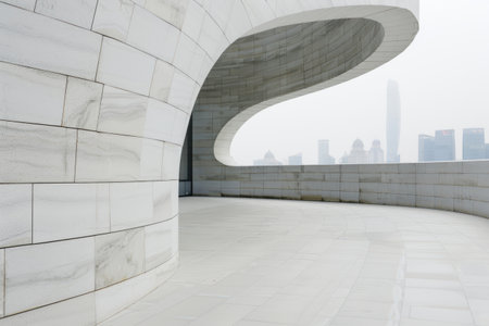 modern architectural design with curved glass facade and city skylineの素材
