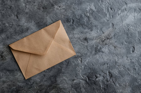 Vintage envelope on a textured concrete backgroundの素材