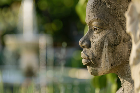 Close-up of weathered stone face sculptureの素材