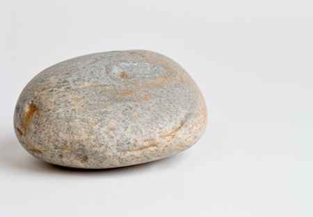 Smooth river stone on white backgroundの素材
