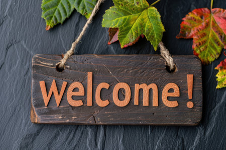 Autumn leaves and welcome sign on wooden boardの素材