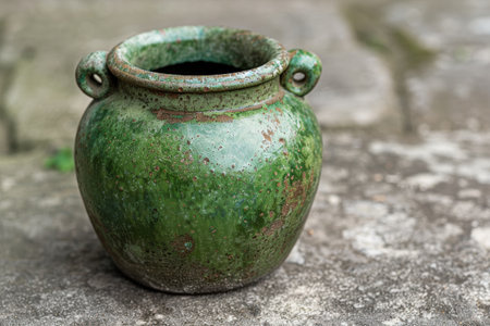Vintage ceramic pot with weathered green glazeの素材