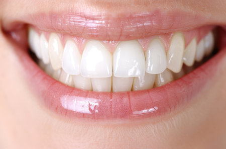 close-up of a smiling mouth with white teethの素材