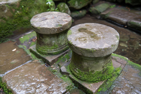 Mossy stone pillars in a serene gardenの素材