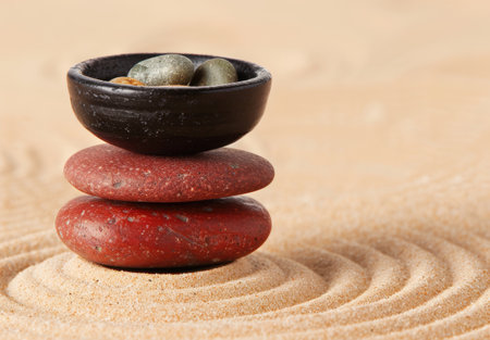 Zen-inspired rock garden with bowl of stonesの素材