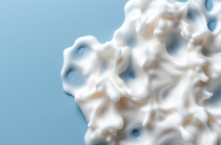 Creamy white foam texture on blue backgroundの素材