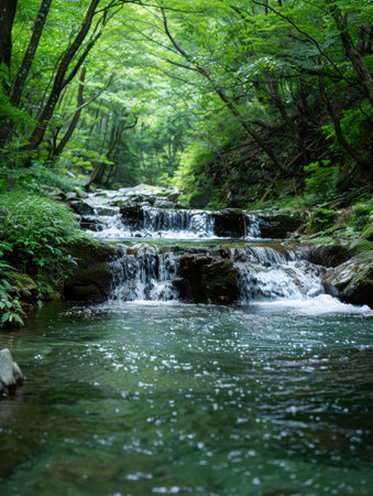 Serene forest waterfall in lush green landscapeの素材