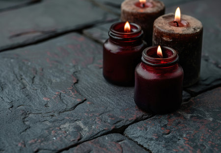 Moody candle arrangement on dark backgroundの素材