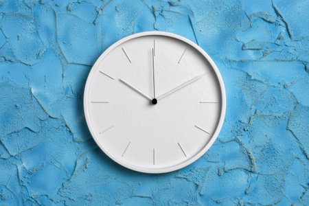 modern minimalist wall clock on blue textured backgroundの素材