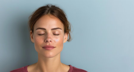 woman with eyes closed in thoughtful expressionの素材