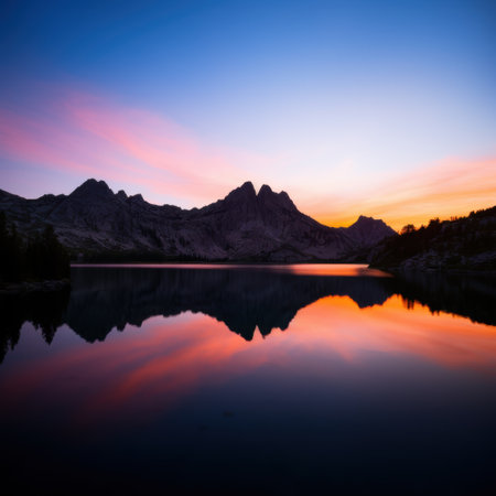 Majestic mountain landscape reflected in serene lake at sunsetの素材