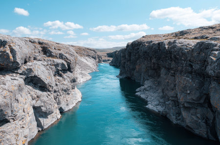 Stunning turquoise waters flowing through rugged canyonの素材