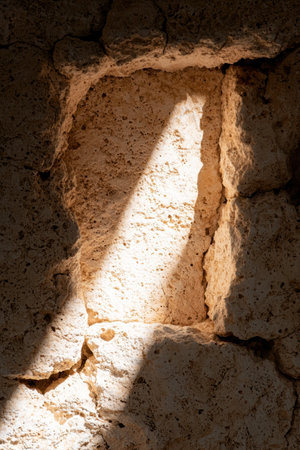 Dramatic lighting illuminating a rugged cave interiorの素材