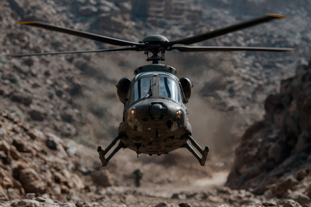 military helicopter flying over rocky terrainの素材