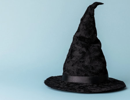 black witch hat on teal backgroundの素材