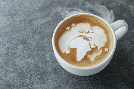 steaming hot coffee with world map latte artの素材