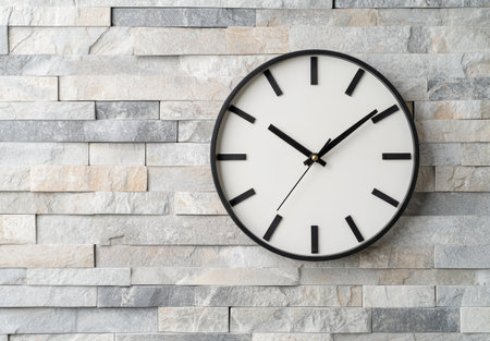 modern minimalist wall clock on stone tile backgroundの素材