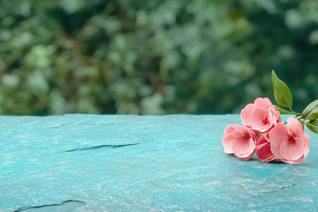 Pink flowers on a turquoise stone surfaceの素材