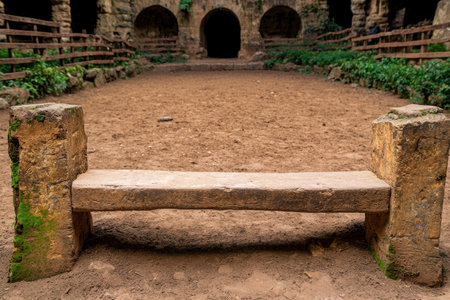 ancient stone bench in a secluded gardenの素材