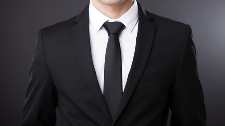 Businessman in a black suit and tieの素材