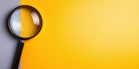 magnifying glass on yellow backgroundの素材
