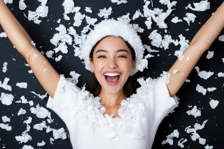 joyful woman enjoying snowfallの素材