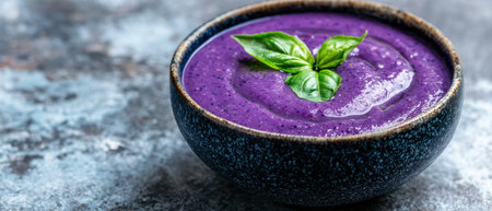 Vibrant purple smoothie bowl with fresh basil garnishの素材