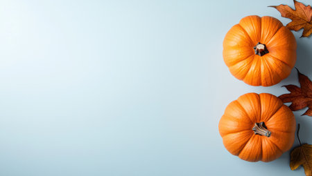 Autumn pumpkins and leaves on light backgroundの素材