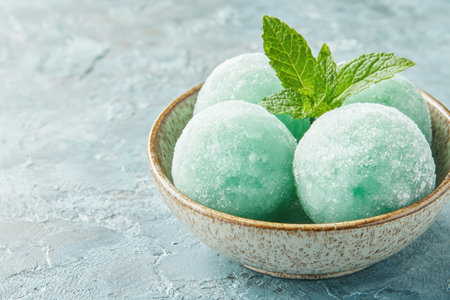 Refreshing green mint ice cream scoops in a bowlの素材
