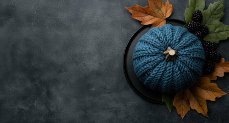 Cozy autumn still life with knitted pumpkin and fall leavesの素材