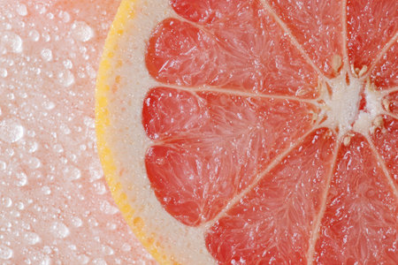 Juicy grapefruit slices with water dropletsの素材