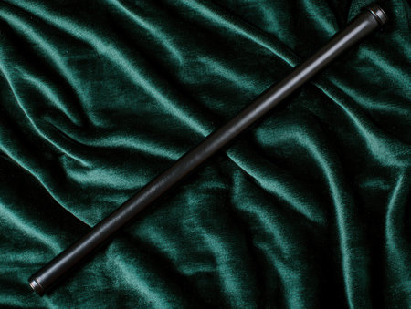 Wooden baseball bat on dark green velvet backgroundの素材