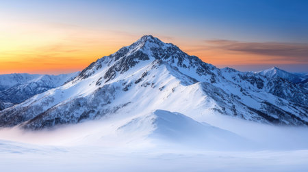Majestic snow-capped mountain peak at sunsetの素材