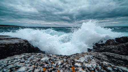 powerful ocean waves crashing against rocky shoreの素材