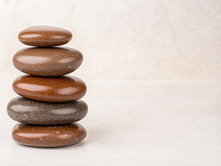 Stacked smooth river rocks in natural tonesの素材
