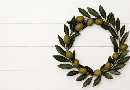 Olive wreath on white wooden backgroundの素材