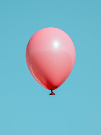 floating pink balloon on blue backgroundの素材