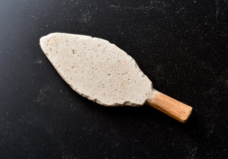 Antique stone mortar and pestle on black backgroundの素材