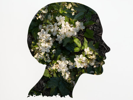 silhouette of a person's head surrounded by blooming flowersの素材