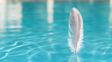 Delicate feather floating on tranquil waterの素材