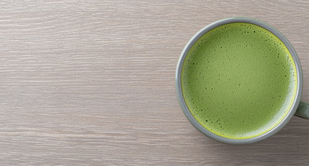 green matcha tea latte in glass on wooden tableの素材