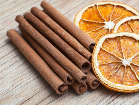 Cinnamon sticks and dried orange slices on wooden backgroundの素材