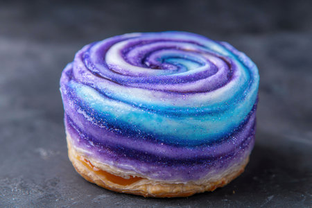 Vibrant swirled pastry with colorful glazeの素材