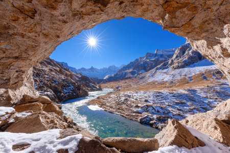 Scenic mountain landscape with snow-capped peaks and a frozen riverの素材
