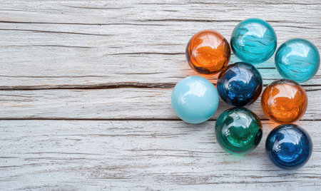 Colorful glass marbles on rustic wooden backgroundの素材