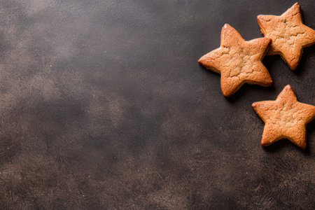 Homemade gingerbread star cookies on dark backgroundの素材